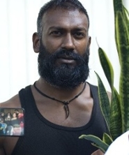 Portrait of Fazle Shairmahomed in black and white in an oval shape.