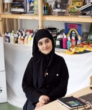 Portrait of Lamiae El Hajjaji in black and white in an oval shape.