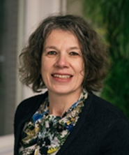 Portrait of Nathal Dessing in black and white in an oval shape.