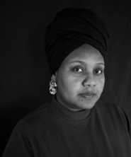 Portrait of Ola Hassanain in black and white in an oval shape.