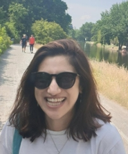 Portrait of Yasmin Ismail in black and white in an oval shape.