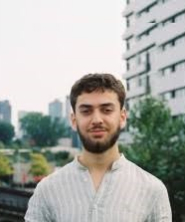 Portrait of Abdallah Abu Ayyash in black and white in an oval shape.